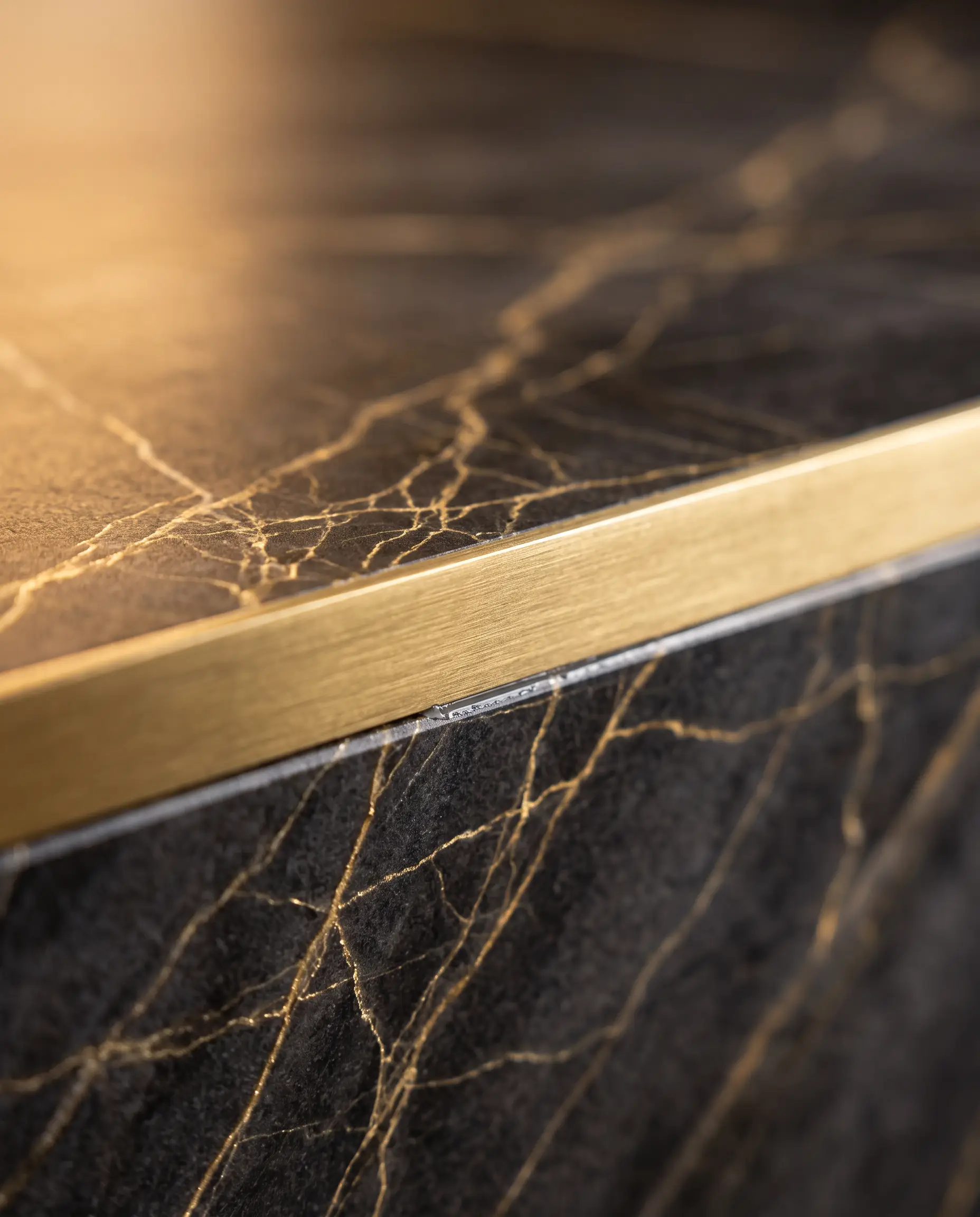 Dark marble with gold veining and a brass edge